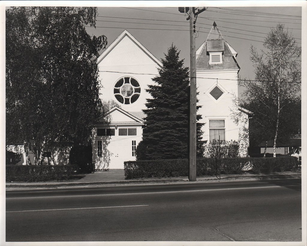Latvian Evangelical Lutheran Church, 1030 Portage, Kalamazoo, c1982. Front view, partially obscured by trees. P-1393